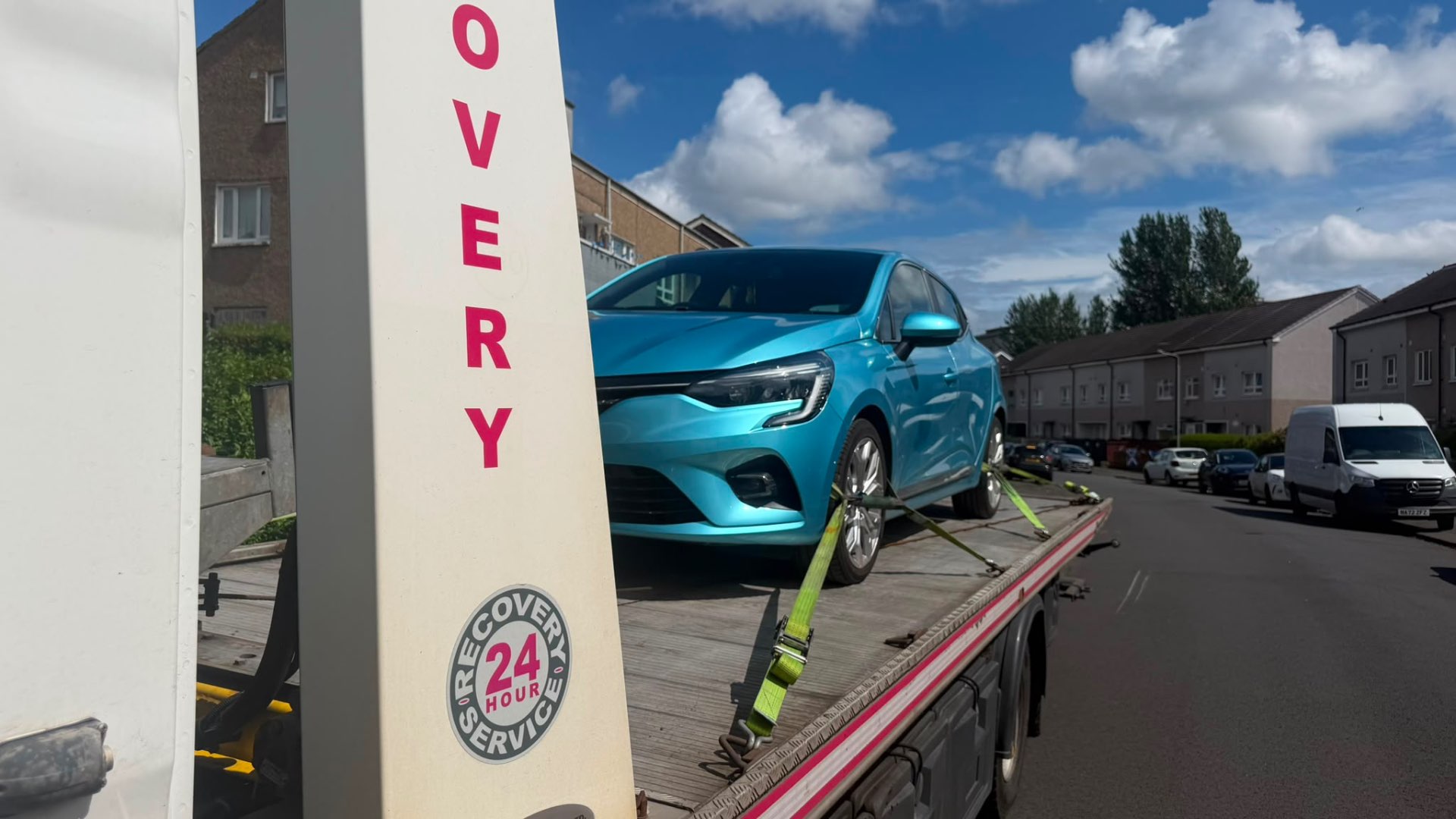 Turquoise Renault Clio secured on 24-hour recovery flatbed