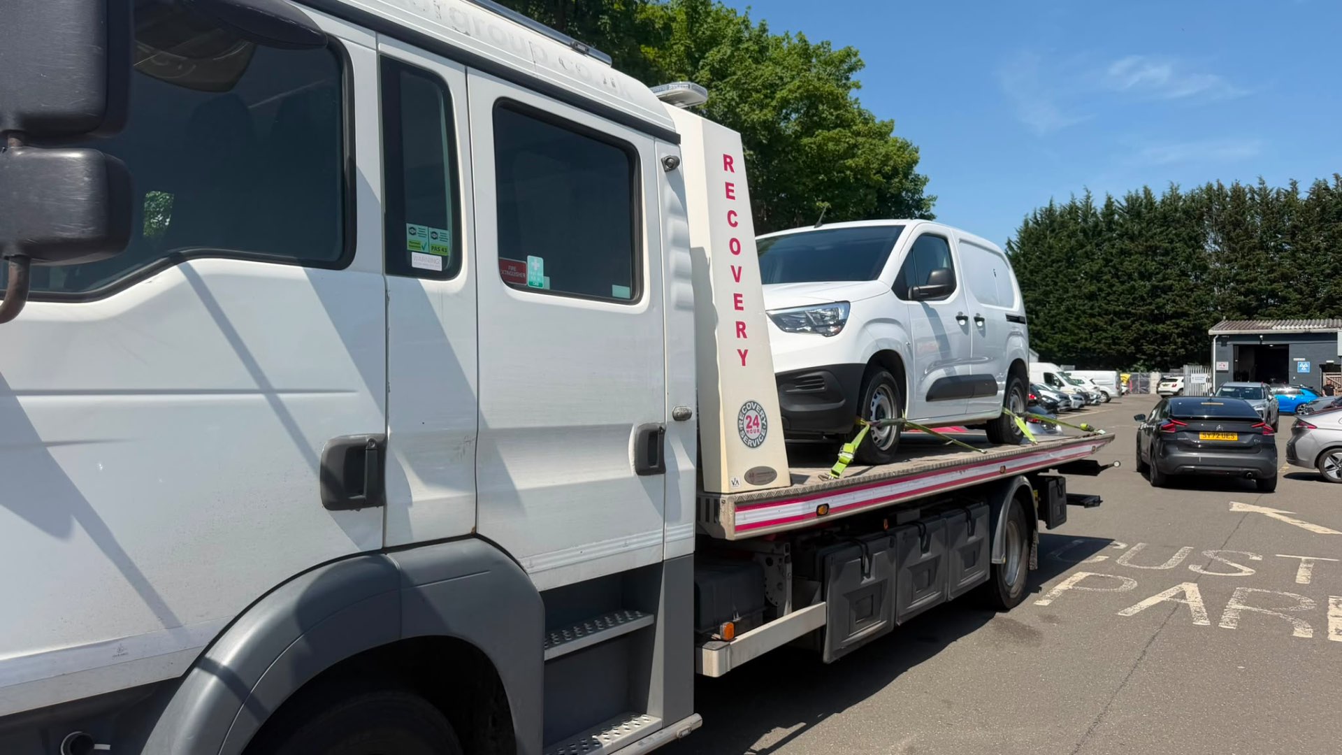 White Vauxhall Combo van loaded on MZL recovery flatbed