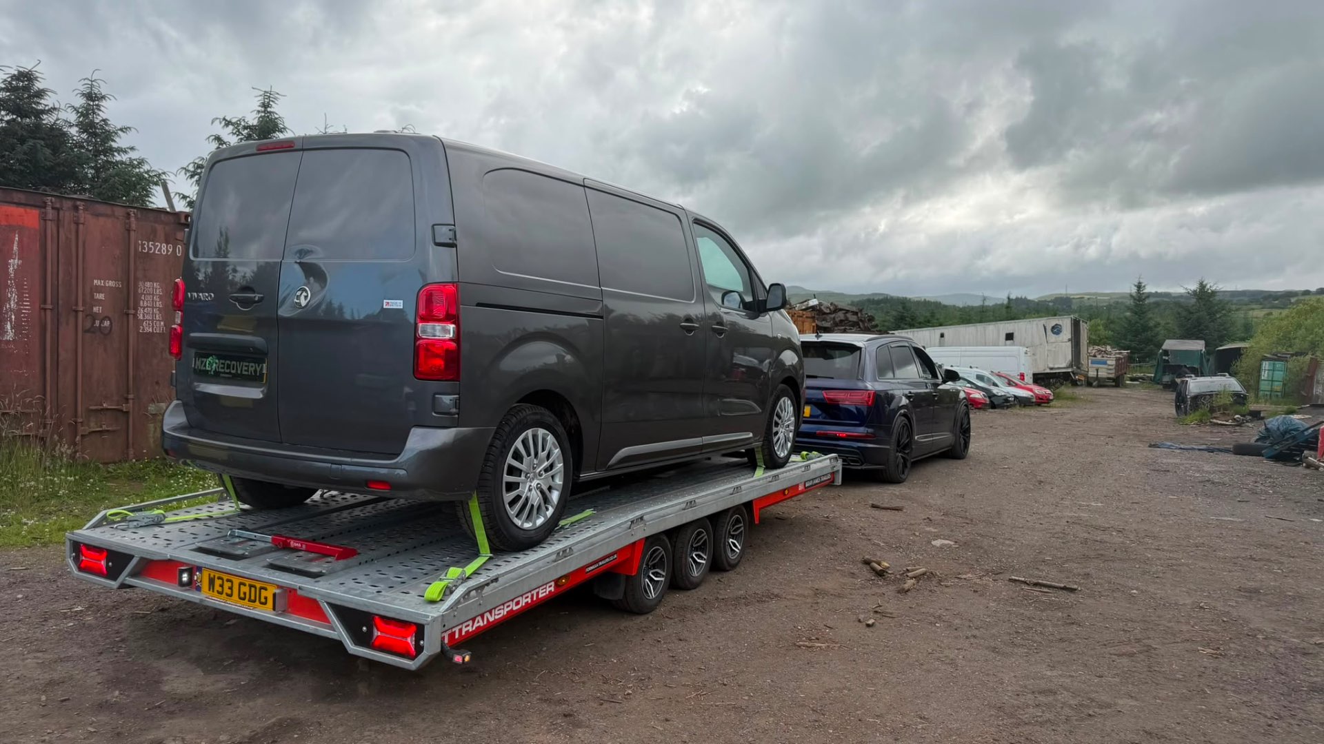 Vauxhall Vivaro MZL Recovery van on covered transporter towed by Audi SQ7