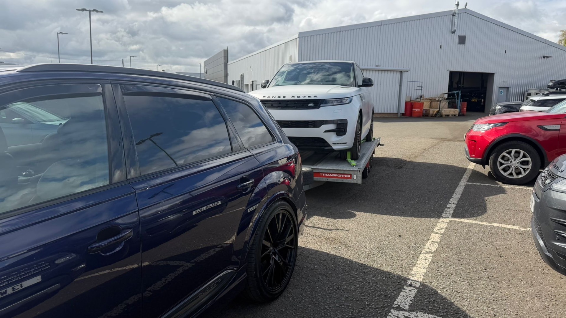 White Range Rover Sport delivery on transporter