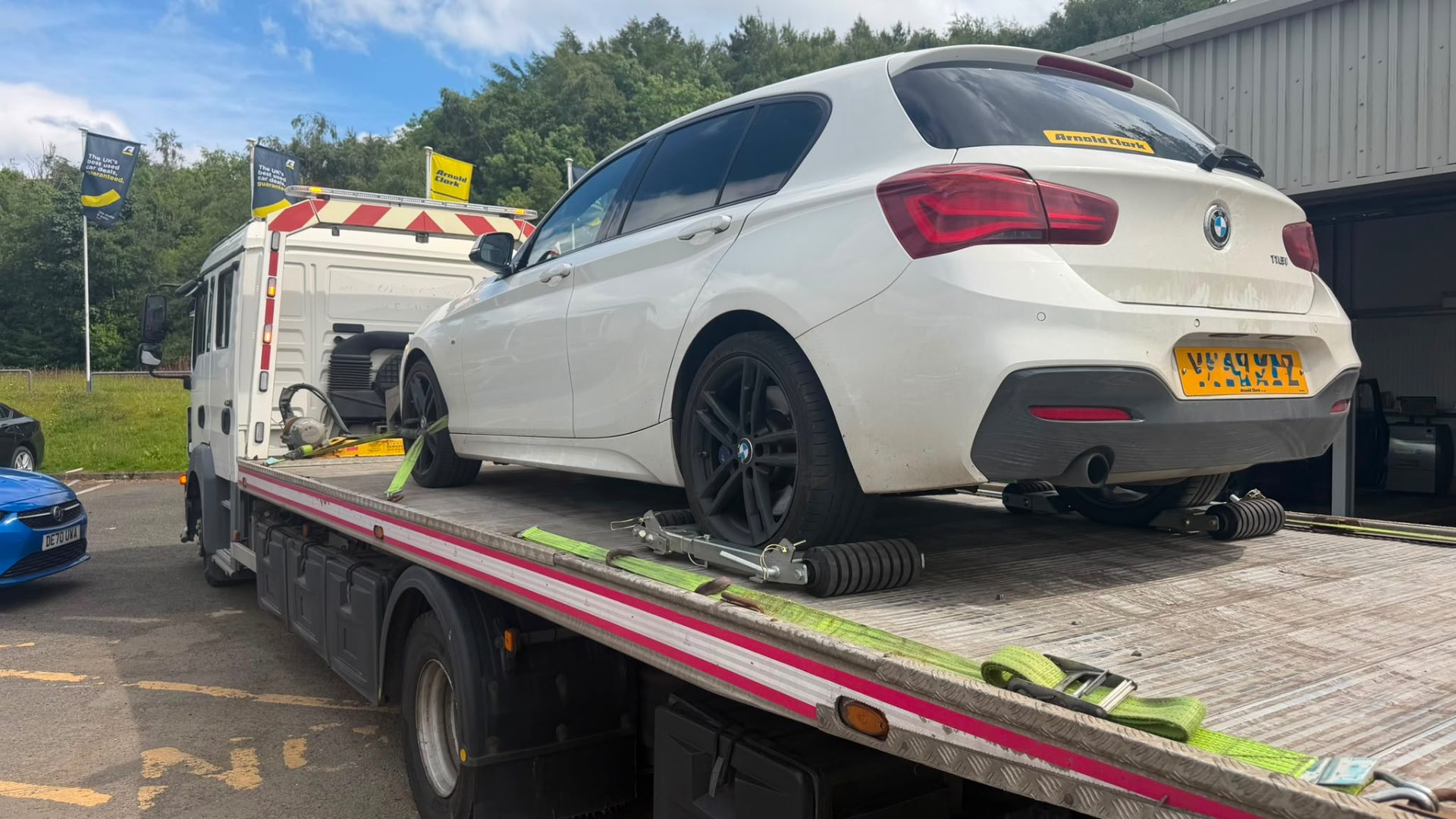 White BMW 1 Series M Sport loaded on MZL recovery flatbed at Arnold Clark