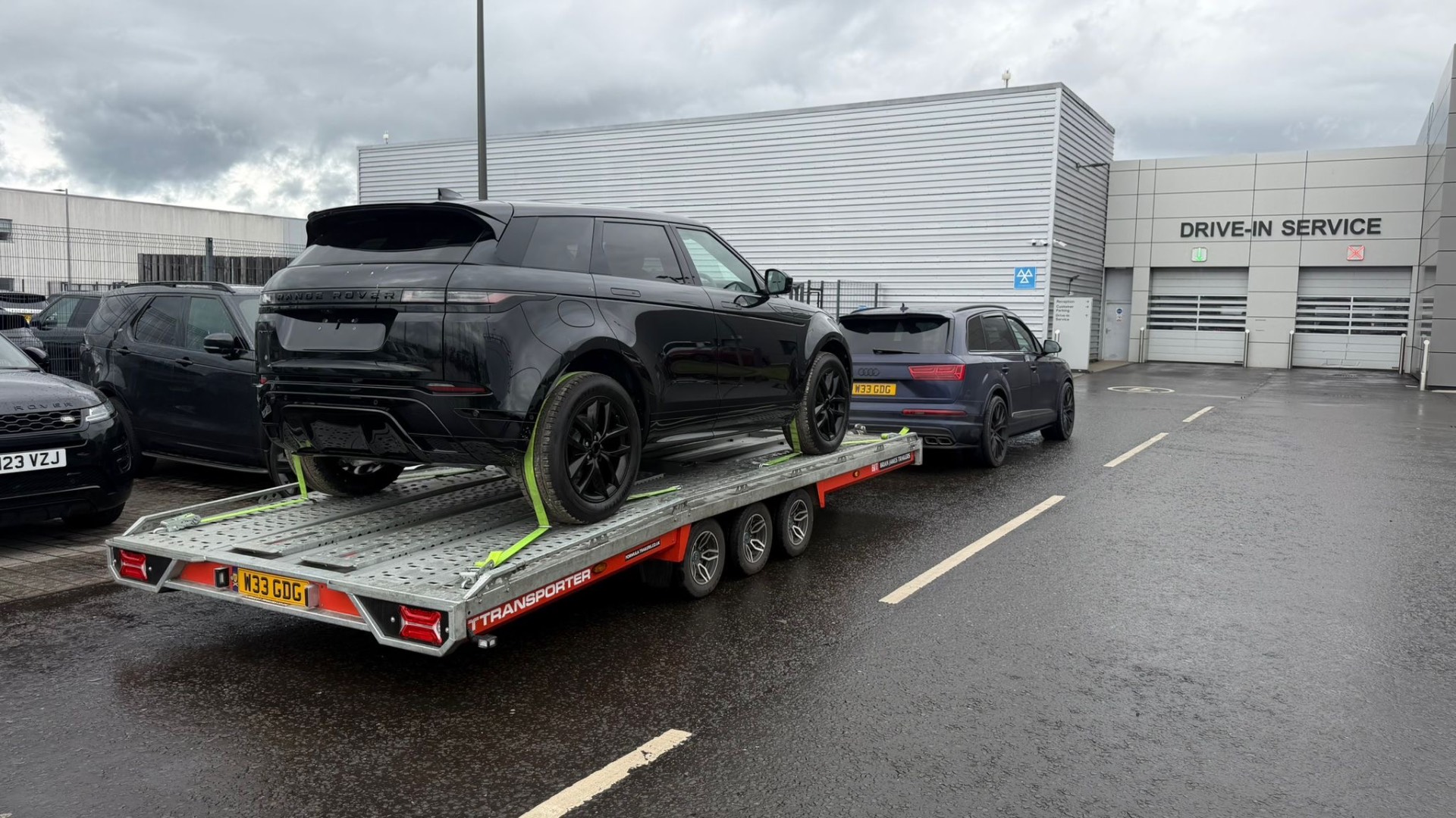 Black Range Rover Evoque on transporter at dealership