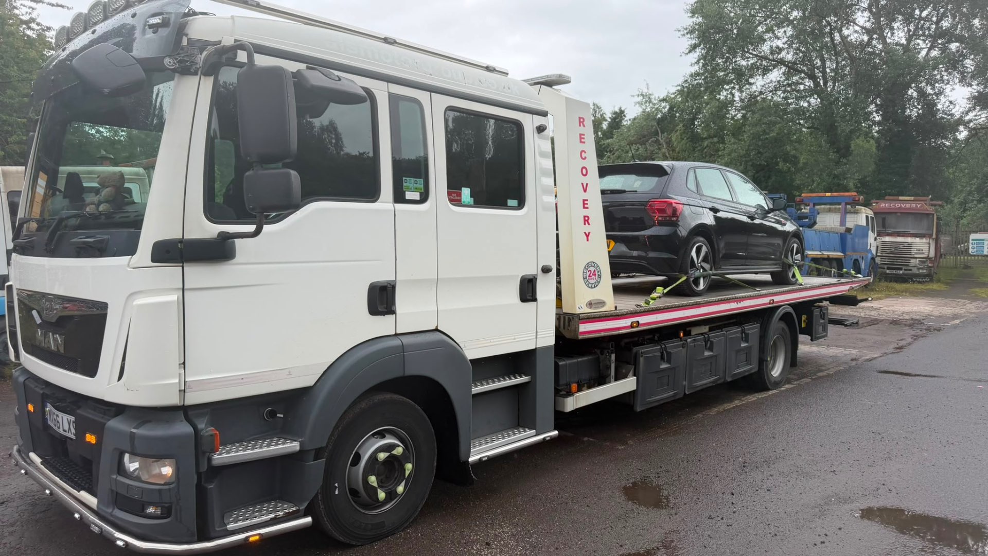 MAN 24-hour recovery truck with black VW Polo on flatbed