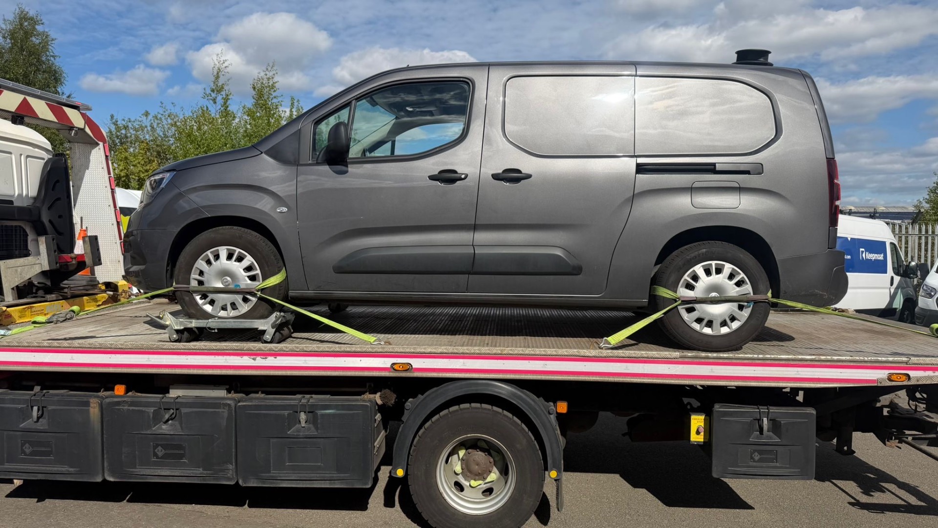 Grey Vauxhall Combo van side view on recovery truck