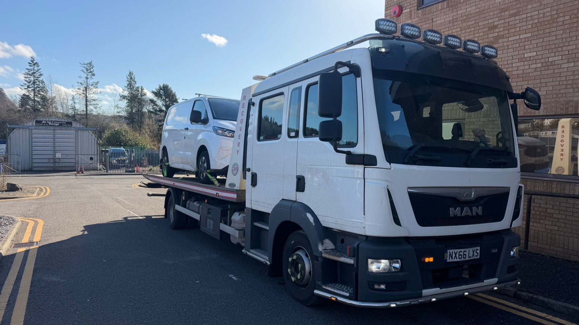 MAN recovery truck transporting a Ford Transit van