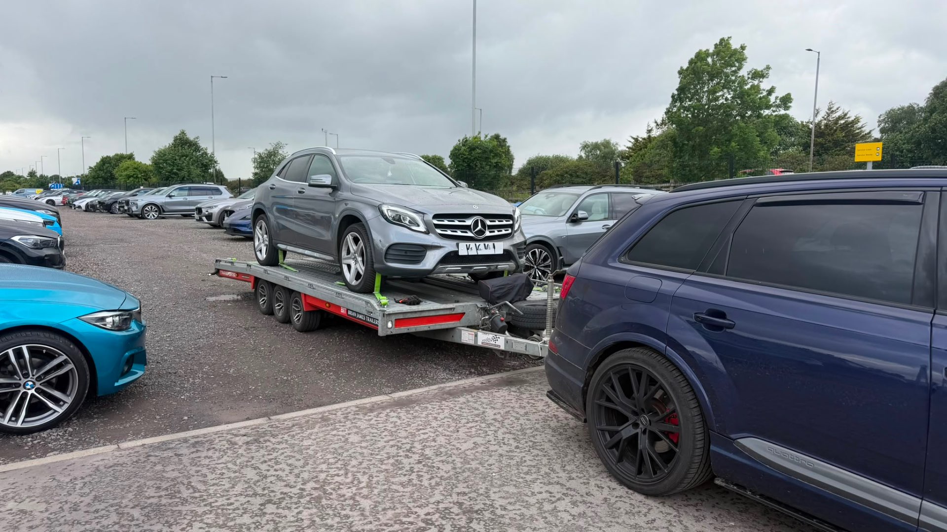 Mercedes GLA on covered transporter towed by Audi SQ7 at Arnold Clark