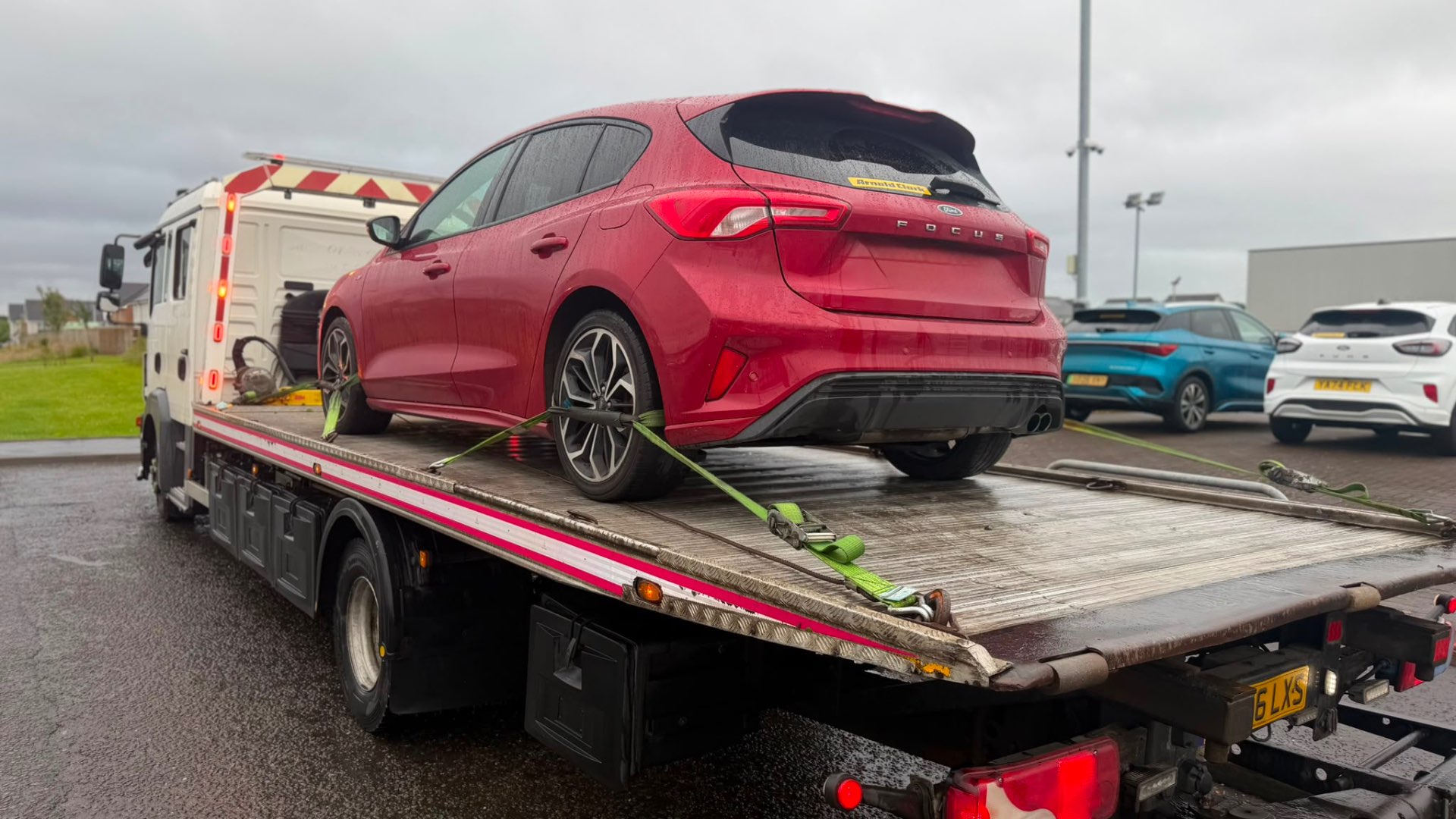 Red Ford Focus ST-Line loaded on MZL recovery flatbed at Arnold Clark